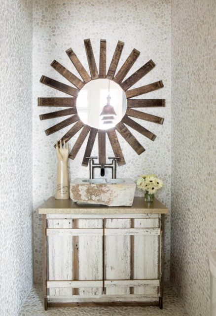 The designer’s singular point of view is, in fact, evident throughout the house, right down to the powder room mirror made of wine barrel staves and the sculptural Don Quixote greeting visitors at the front door.