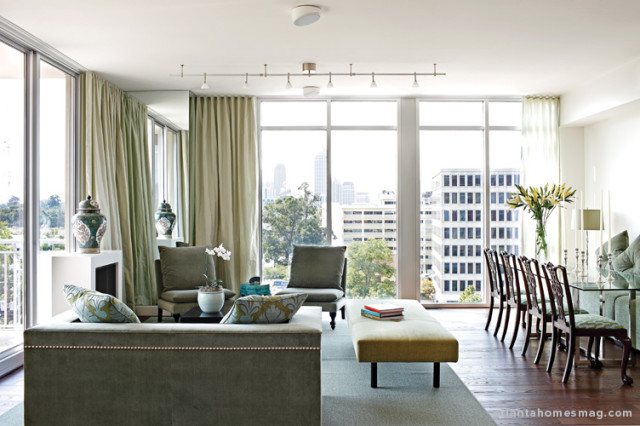 A bit of design brilliance is barely discernable in the living/dining area—and that’s what makes it so ingenious. “Construction columns were interfering with the windows,” says designer John Oetgen, “so I mirrored them floor to ceiling, to provide even more reflection and confusion of light.” What’s more, it gives the curtains an uninterrupted look.