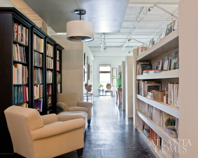 Photography by Christina Wedge. A drum fixture descends from a suspended ceiling in the library, which offers a bit of coziness to contrast the high, open ceilings.