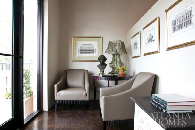 Photography by Christina Wedge. An 18th-century Grand Tour bronze bust from Parc Monceau and a Mid-Century French wire lamp are perched on a round table that stands between a pair of lounge chairs.