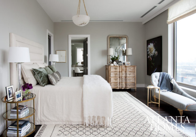 Westbrook based the master bedroom’s cream, grey, and lavender color palette on hues found in Whitney Ott’s floral photograph, which is positioned alongside an antique French wooden chest. The designer notes that most of the home’s antiques “have a Continental feel to them.”