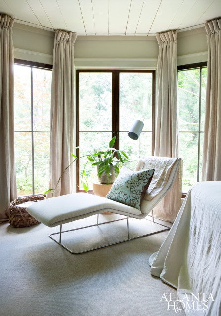 The master bedroom exudes European luxury with its interesting mix of periods, colors and styles. Improvisation—in the form of a custom tapestry headboard and a pair of antique linens sewn together to make a coverlet—is further evidence of the creative energy and joie de vivre that pervades the house.