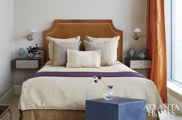 A velvet headboard is the focal point in a guest bedroom; floating drawers create the illusion of space.