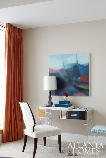 A mirrored vanity table from The Martin Group and a Robert Allen chair provide an elegant spot to get ready for the day.