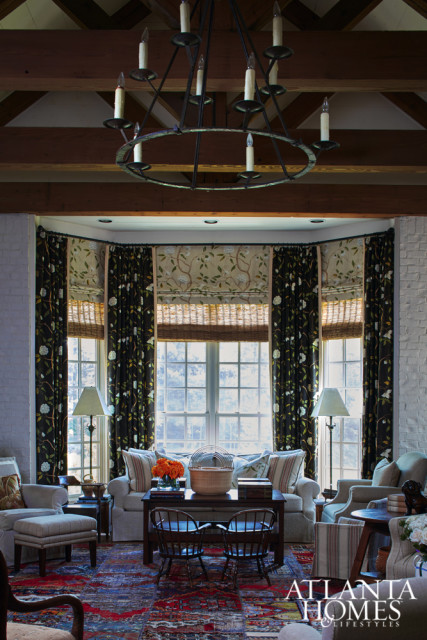 The bay window is dressed in both black and cream versions of Cowtan & Tout’s “Snow Tree” fabric. “Nothing is prettier, when you look out the window and see flowers blooming, than to see flowers inside, too,” says Topol.