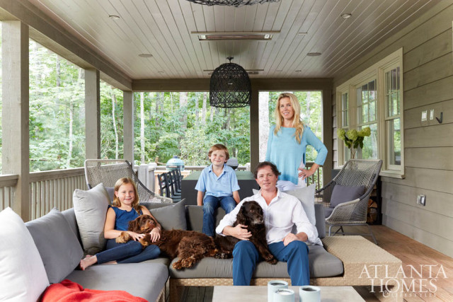 Homeowners Jennifer and Bonneau Ansley, shown on their back porch with daughter Blakely and son Beau, sought to create a modern yet cozy retreat. The outdoor sectional is from Kolo Collection.