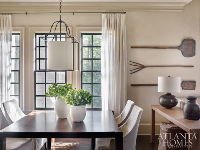 Nick enjoys making furniture in his spare time and put his talents to use in the breakfast room. Here, he made the mahogany table and leather nailhead console. Antique rustic bread paddles add a sense of storied charm.