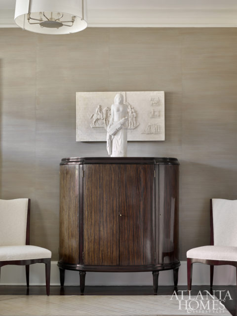 In the foyer, Webb layered a plaster model of the Fort Moore Pioneer Monument with a marble figure.