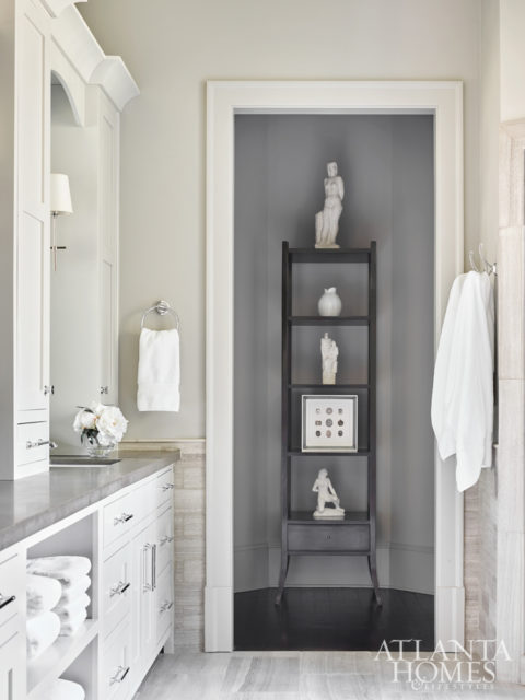 A Barbara Barry for Baker étagère in the master bath highlights plaster maquettes and framed medals.
