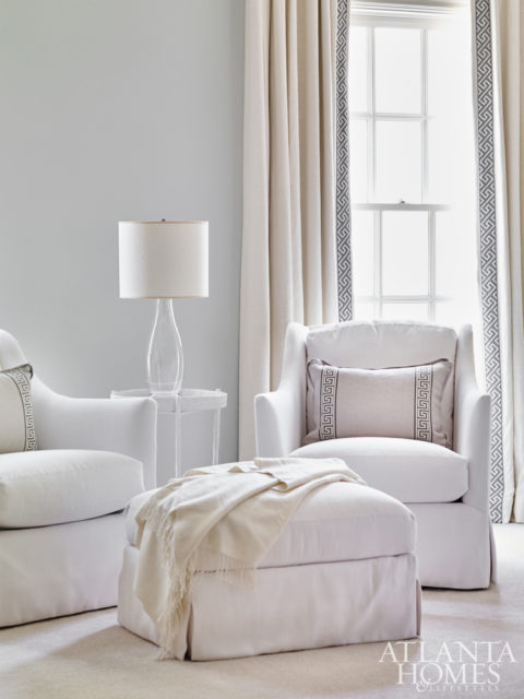 Plush chairs and an ottoman from Bungalow Classic complement the custom headboard.
