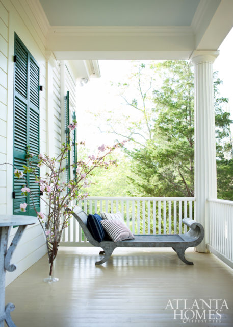 On the spacious porch, a recamier by Mike Reid Weeks serves as a comfortable respite, with pillows from Janus et Cie.