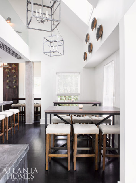 Featuring an white-washed walls, an outdoor patio, dark cherry wood-stained floors and driftwood accents, the restaurant, designed by Kelly Anthony, exudes beachy charm.