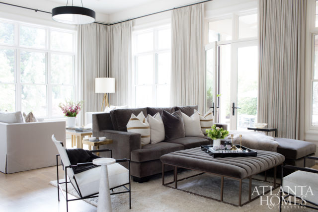 The cozy family room features plush furnishings by Björk Studio plus hide chairs from Oly Studio.