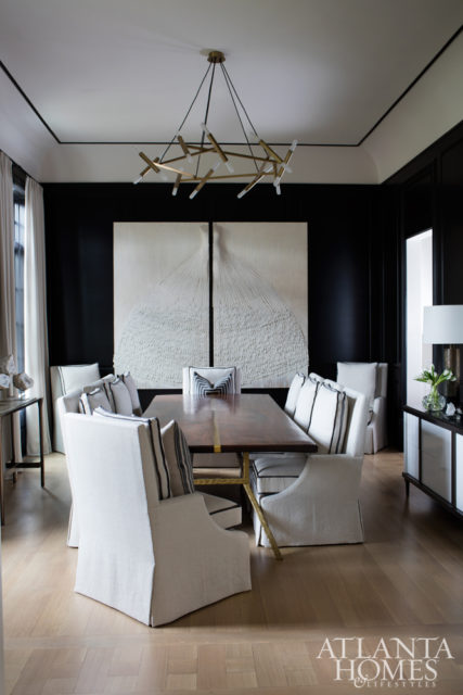 Broaddus plays up her penchant for high-contrast color palettes in the dining room; taking center stage is a mixed-media diptych by Brenda Stumpf, represented by Bill Lowe Gallery. The custom walnut table was a collaboration between Broaddus and Grey Furniture, while the chairs are by Björk Studio. The chandelier and buffet are available through R Hughes.