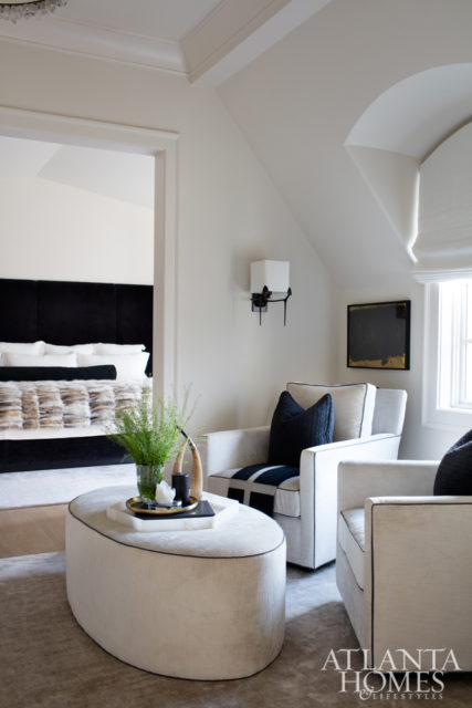 A custom vanity offers the wife a chic spot to start her day, while a cozy seating area just outside the bedroom offers a place to unwind at the day’s end.
