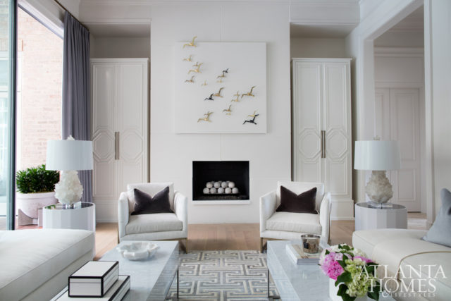 In this serene space off the loggia, quartz lamps by Kathryn McCoy sit pretty on marble tables by Grey Furniture, while soft Donghia-clad seating by Björk Studio rests on a hide rug by Kyle Bunting.