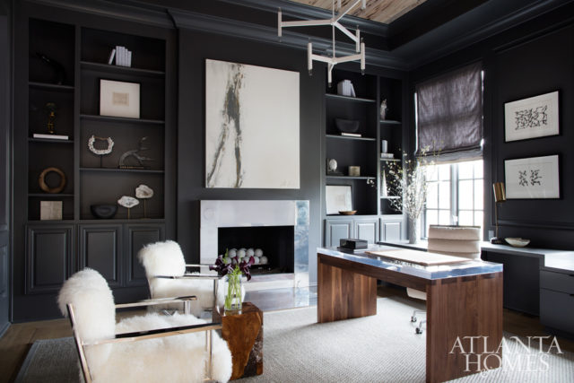 A floor-to-ceiling granite fireplace was removed to make way for a cast aluminum surround by Charles Calhoun. Soft, white accents offset masculine touches such as the acrylic-and-walnut desk. The desk and chandelier are by Grey Furniture, and the chairs are by Mitchell Gold + Bob Williams. Painting, Bonnie Fuchs. Additional artwork, Townhouse by Robert Brown.
