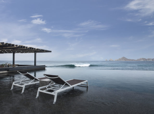 The infinity pool appears to merge with the Sea of Cortes.