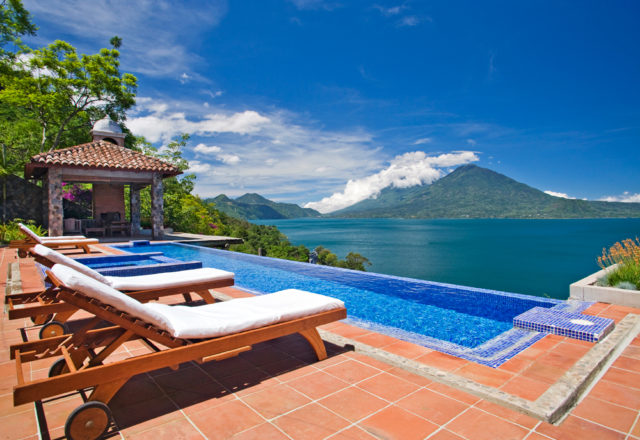 An outdoor pool serves as an idyllic spot to relax with a glass of wine.