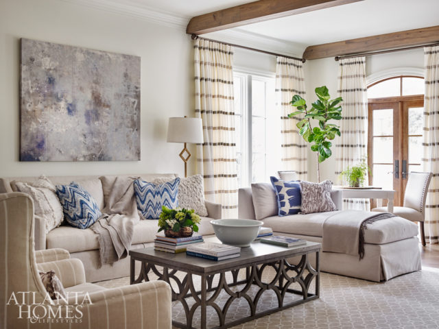 Comfortable and casual reign in the new beamed living room; the Mr. Brown coffee table is an indoor/outdoor piece, while the chaise and game table invite the homeowners and their guests to relax.