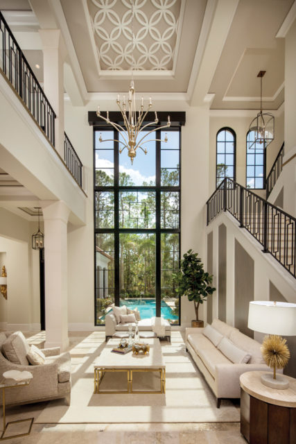 A 20-foot window overlooking the pool is the focal point in the Grand Living Room inside the “Capolavoro” mansion within the Four Seasons Private Residences neighborhood at Golden Oak.
