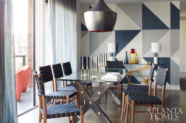 Khandwala and artist Todd Seay conceptualized a blue-and-gray color-blocked wall in the dining room. A hand-hammered copper chandelier from Peachtree Battle Antiques hangs above a Restoration Hardware dining table.