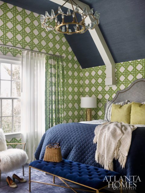 Bright-green lattice wallpaper by Carleton V Ltd., paired with a navy Phillip Jeffries grass cloth ceiling, brings playful drama to the master bedroom. A large-scale parakeet on canvas by Southern artist Jason Horton adds an eclectic touch to the nest.