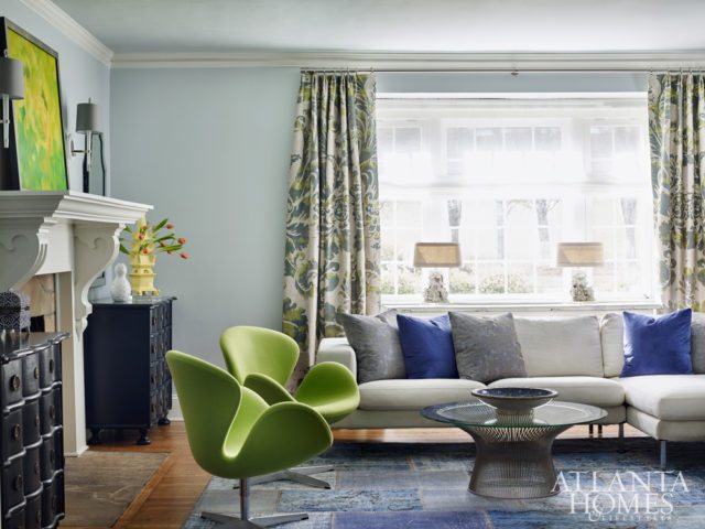 Papadopoulos hesitates to use the term “formal” to describe the living room. While it’s more traditional than the family room, she mixed modern furniture, like the Platner cocktail table and bright-green swan chairs, with antique chests and traditional Jim Thompson silk draperies to keep the space refined yet approachable.