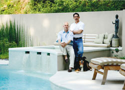 Homeowners Chip Cheatham and Ken Covers relax with dog Sydney in their outdoor living room.