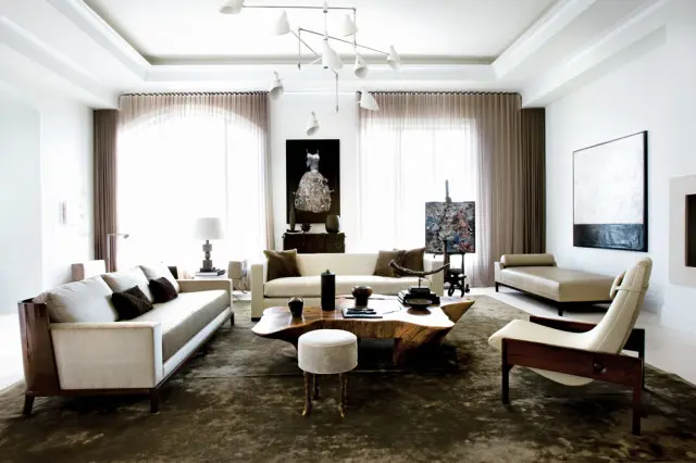 Living room with white sofas, a live-edge wood coffee table, a tan chaise lounge, and modern art on the walls.