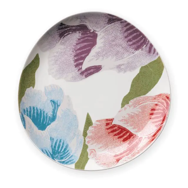 White plate with a pattern of stylized tulips in shades of purple, blue, red, and green.