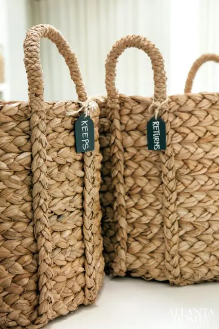 Two woven hyacinth baskets with braided handles, each with a dark tag labeled 'KEEPS' and 'RETURNS'