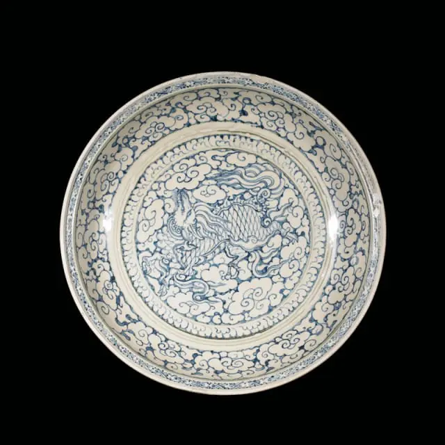 Blue and white porcelain plate with dragon and cloud motif