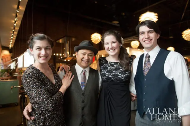 Four people in formal attire pose for a photo indoors, with the Atlanta Homes & Lifestyles logo visible on the right.