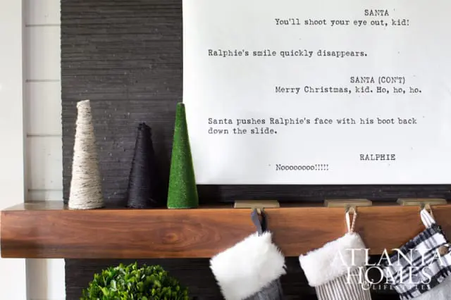 Wooden mantelpiece with Christmas stockings, cone-shaped decorations, and a script from "A Christmas Story" featuring dialogue from Santa and Ralphie.