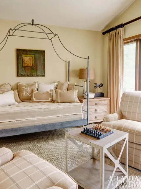 As expected in a mountain home, it was the view that ultimately inspired Edwin Lusk and David Paterson, owners of the Cashiers-based Fletcher and Lee, to create a relaxing retreat to enjoy after a day of riding, whether to read, play chess or relax with family or guests. The duo selected the day bed from Zentique because of its unusual style; it is accompanied by Mr. Brown side chests and an English antique painted chest of drawers from their firm.