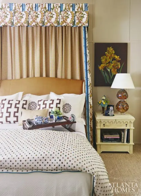 For a small mountaintop bedroom with high ceilings, Kathryn Greeley was inspired by an old French linen print, "Jossel," by Brunschwig and Fils. The fabric created drama in the room, where old and new pieces mixed for a "collected look." Among the old: two antique leather wing chairs, an antique Scottish chest and a faux bamboo bookcase filled with a collection of antique majolica. For the new, Greeley designed custom bedside tables with The Gilded Stag in Arkansas and added an upholstered bed and a mirror by Bunny Williams. Custom hand-blown glass lamps by David Goldhagen of Hayesville, NC, and over-scaled original botanicals from Rosemary Clark Stiefel of Highlands lent an updated feel.