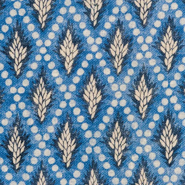 Blue fabric with a repeating pattern of cream-colored stylized leaves and white polka dots.
