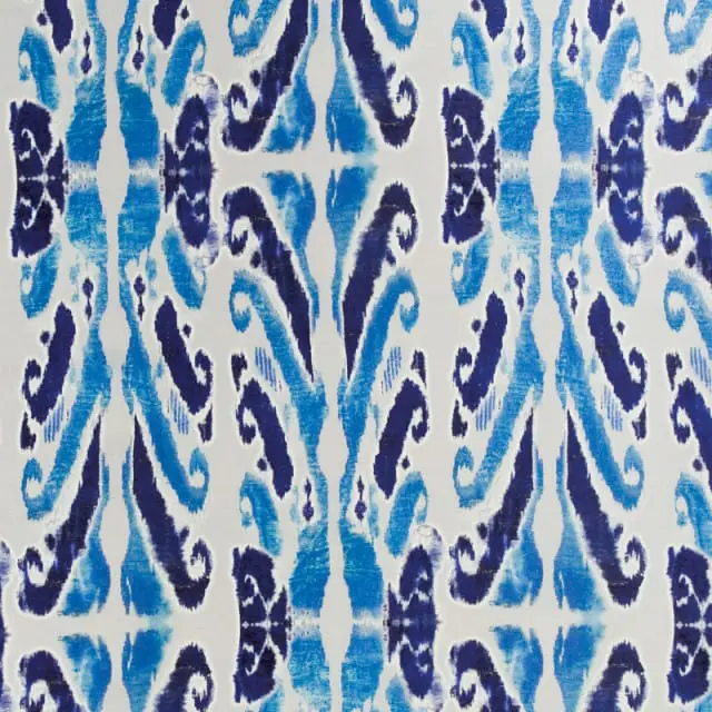 Abstract ikat pattern in varying shades of blue on a white background.