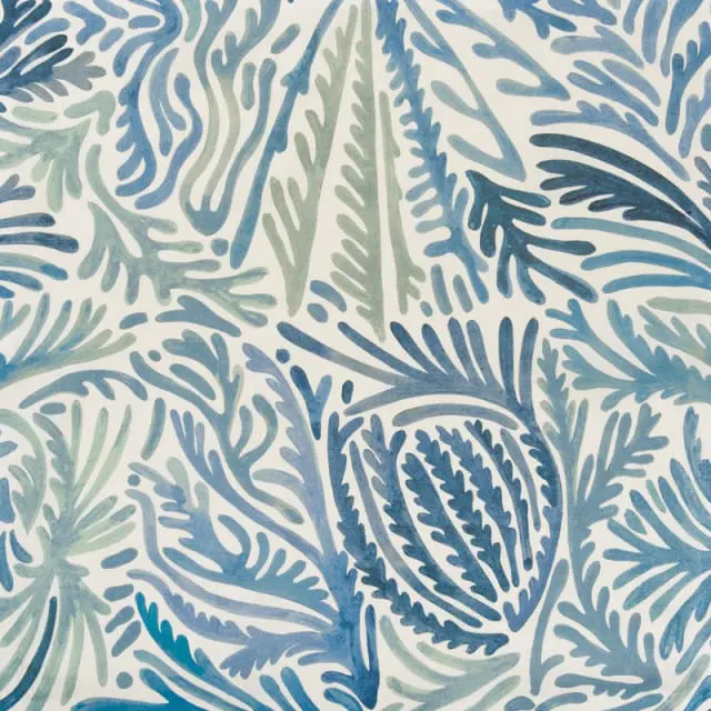 Close-up of a blue and green watercolor pattern resembling coral and seaweed on a white background.