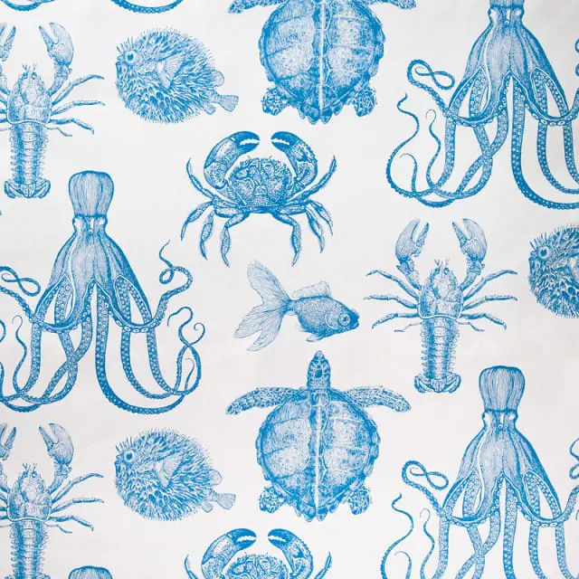 Blue and white toile pattern featuring illustrations of lobsters, octopuses, crabs, turtles, pufffish, and goldfish.