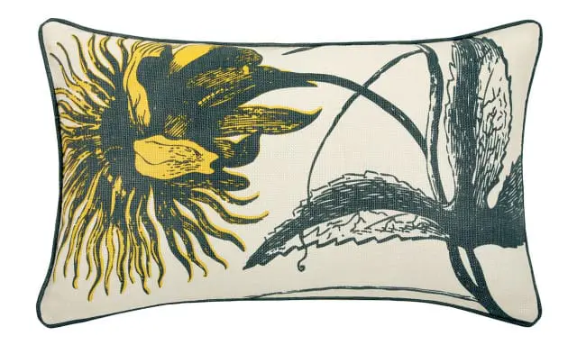Rectangular throw pillow with a botanical print of a sunflower and leaves in yellow and dark teal on a cream background.