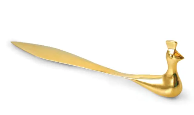Brass letter opener shaped like a peacock, with a pointed blade and a decorative peacock head and body.