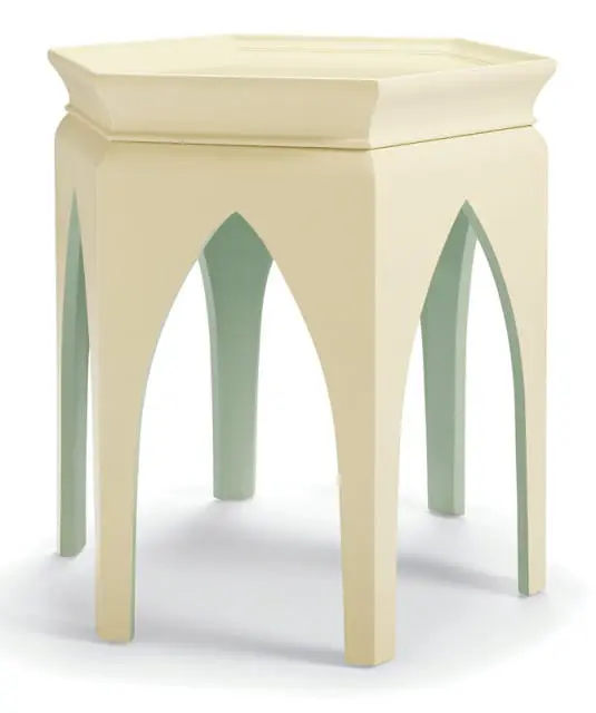 Cream-colored octagonal table with arched cutouts revealing a pale green interior and tapered legs.