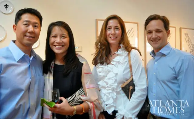 Four people smiling at the camera, two men in blue shirts and two women in dresses. The Atlanta Homes & Lifestyles logo is visible on the right.