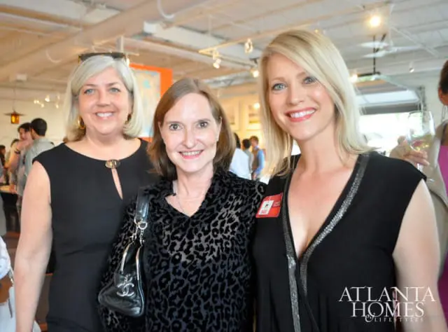 Three women smiling at the camera, with the Atlanta Homes & Lifestyles logo in the lower right corner.