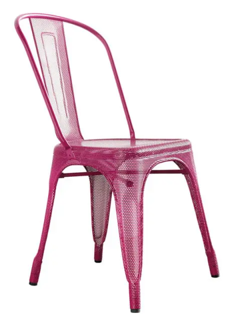 Close-up of a perforated pink metal chair with a curved back and four tapered legs.