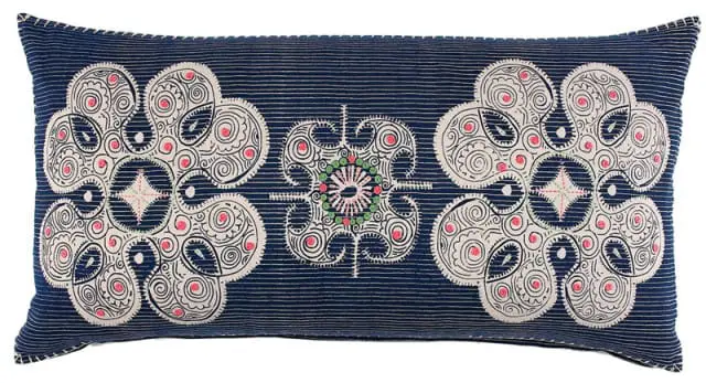 Rectangular pillow with navy blue pinstripe fabric and embroidered cream-colored floral medallions with pink and green accents