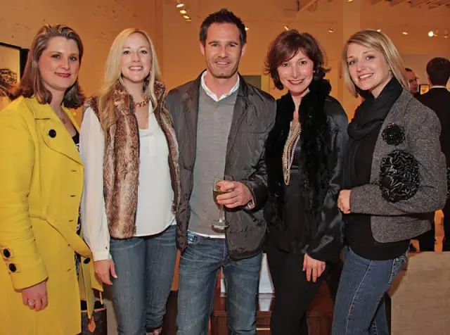 Five people posing for a photo, two women on the left, one man in the center, and two women on the