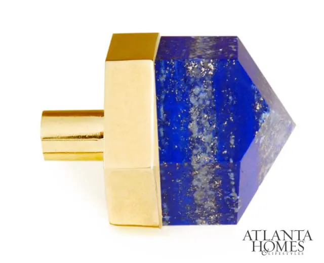 Geometric lapis lazuli knob with gold hardware, featuring a faceted blue stone with gold flecks and a polished gold stem.